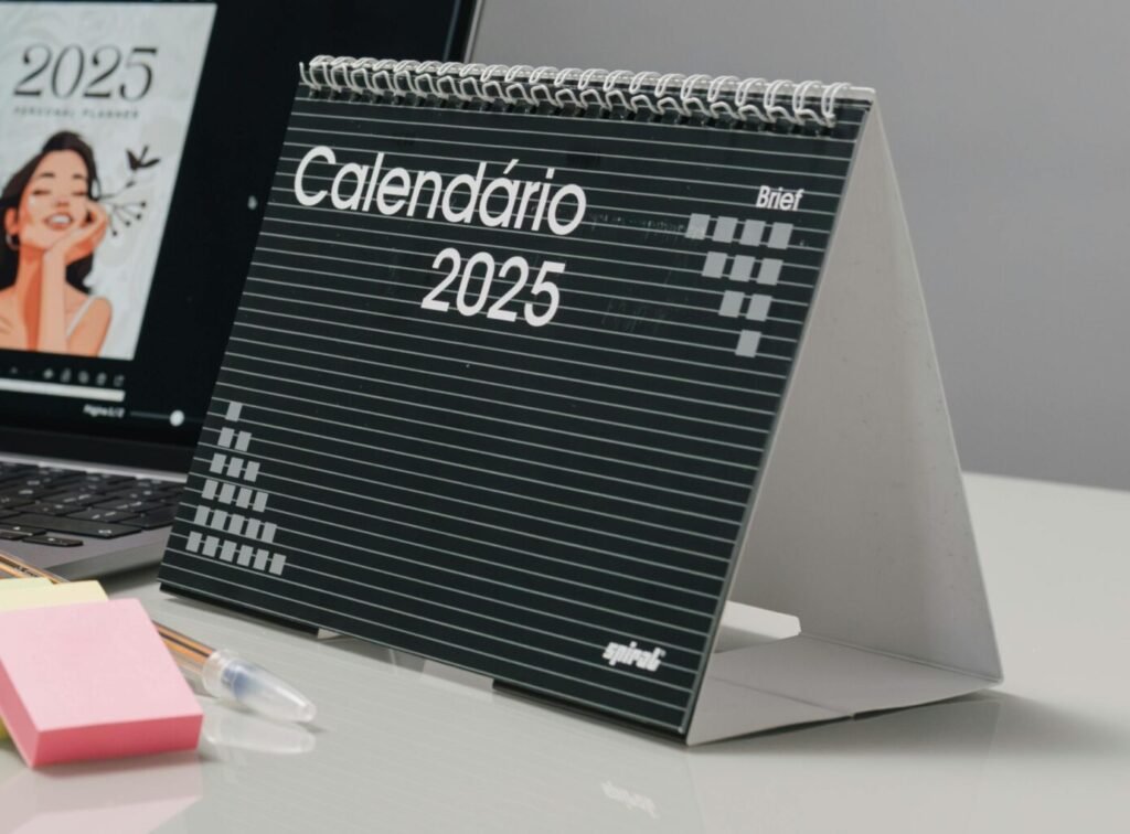 Modern office desk featuring a 2025 calendar, laptop, and coffee for a productive work environment.